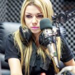 Female radio DJ looking at computer screen