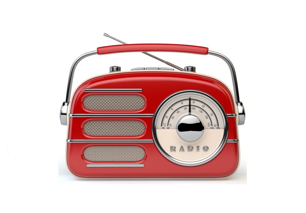 Red vintage retro radio receiver isolated on white.