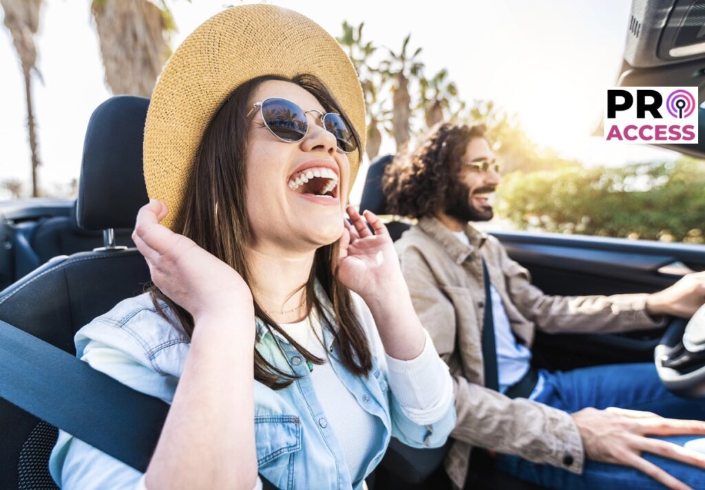 Happy couple driving convertible car enjoying summer vacation - Friends rent cabrio auto on holiday - Roadtrip, freedom, travel and transport rental service concept