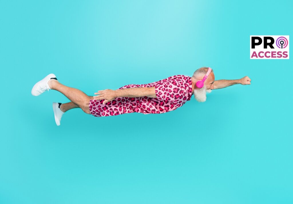 Full size photo of retired bearded male flying superhero headphones wear pink leopard print outfit isolated on aquamarine color background