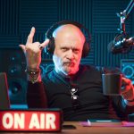Cool radio host making the sign of the horns