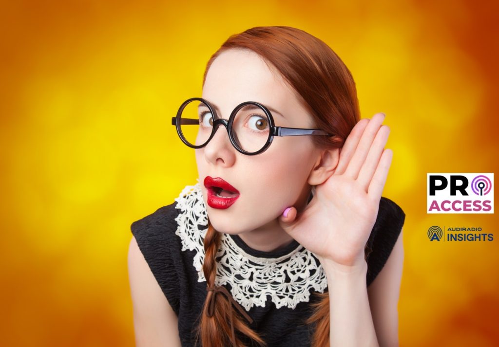 Surprised redhead girl on yellow background.
