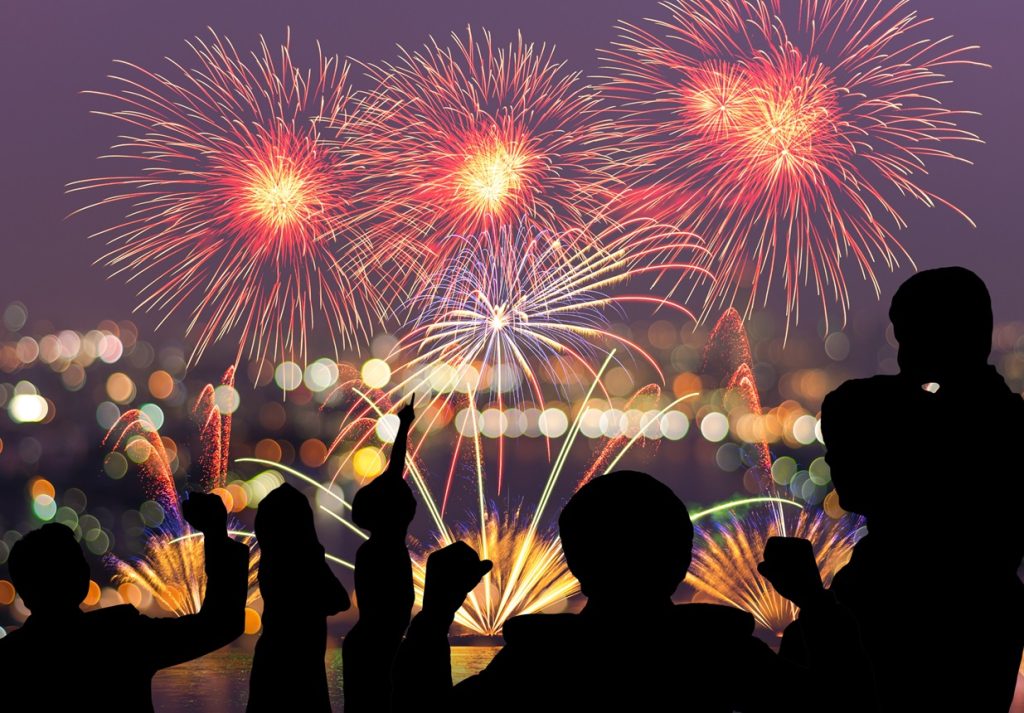 The people looks Fantastic festive new years colorful fireworks on cityscape blurred photo bokeh,project success, holiday concept, family concept