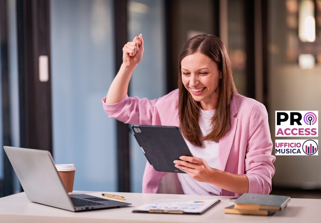 Young woman celebrates success happily at desk with laptop. Raise your hands with joy Excitement and financial success