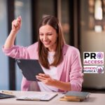 Young woman celebrates success happily at desk with laptop. Raise your hands with joy Excitement and financial success
