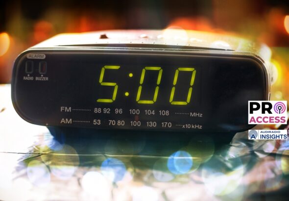 Black digital alarm radio clock.Alarm radio clock indicating time to wake up.Digital clock closeup displaying 5:00 o'clock.