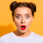 Close-up portrait of her she nice attractive lovely puzzled girl opened mouth stunning news isolated over bright vivid shine yellow background