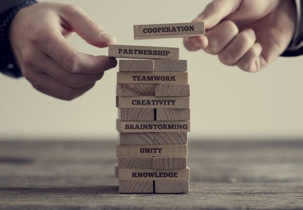 Stack of wooden dominoes with signs
