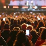 many people with smart phones at live concert