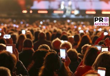 many people with smart phones at live concert