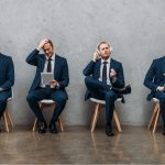 collage of cloned young businessman sitting on chairs and using gadgets