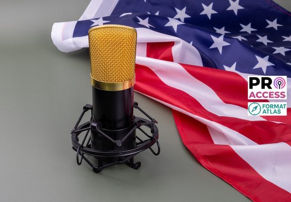 A gold microphone stands proudly before the American flag, ready to capture important voices.