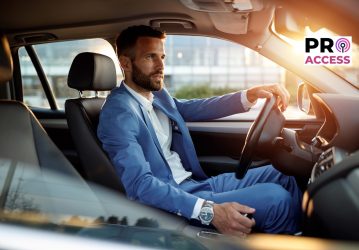 Attractive man in business suit driving car