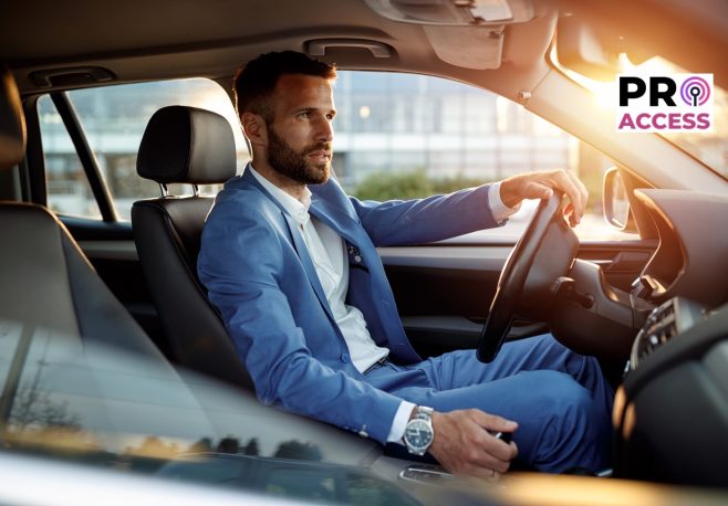 Attractive man in business suit driving car