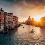 Iconic view of Grand Canal with Santa Maria della Salute and classic building during sunrise in Venice, Italy