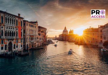 Iconic view of Grand Canal with Santa Maria della Salute and classic building during sunrise in Venice, Italy
