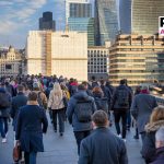 Crowds of commuters on London Bridge rushing into the City