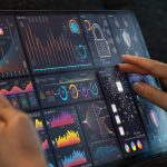 Analyst use laptop working with business analytics and data management system, make a report with KPI and metrics connected to database.Corporate strategy for finance, operations, sales, marketing