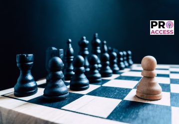 A single white pawn stands against an entire board of black chess pieces. Representative of a one man army/business leader standing against the competition - with room for text